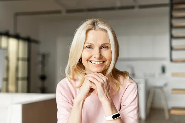 Joyful white woman showing off her beautiful teeth with dental veneers from Grins & Giggles Family Dentistry in Spokane Valley, WA