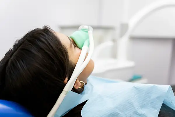 Patient receiving nitrous oxide sedation through a mask at Grins & Giggles Family Dentistry in Spokane Valley, WA